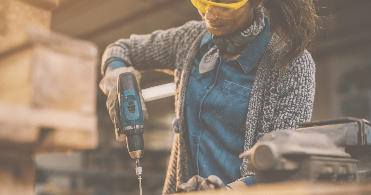 Person using a power drill in a woodworking shop